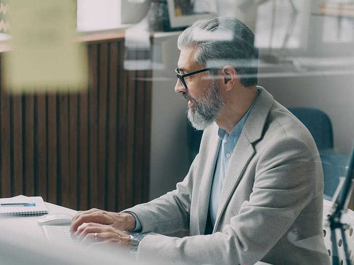 A professional reading through his results at his desk
