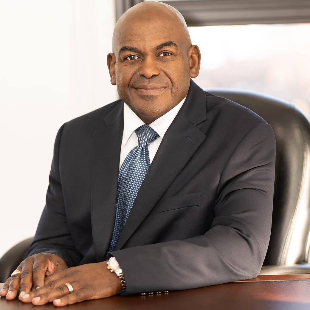 Dr. Rupert A. Hayles Jr. seated in his office