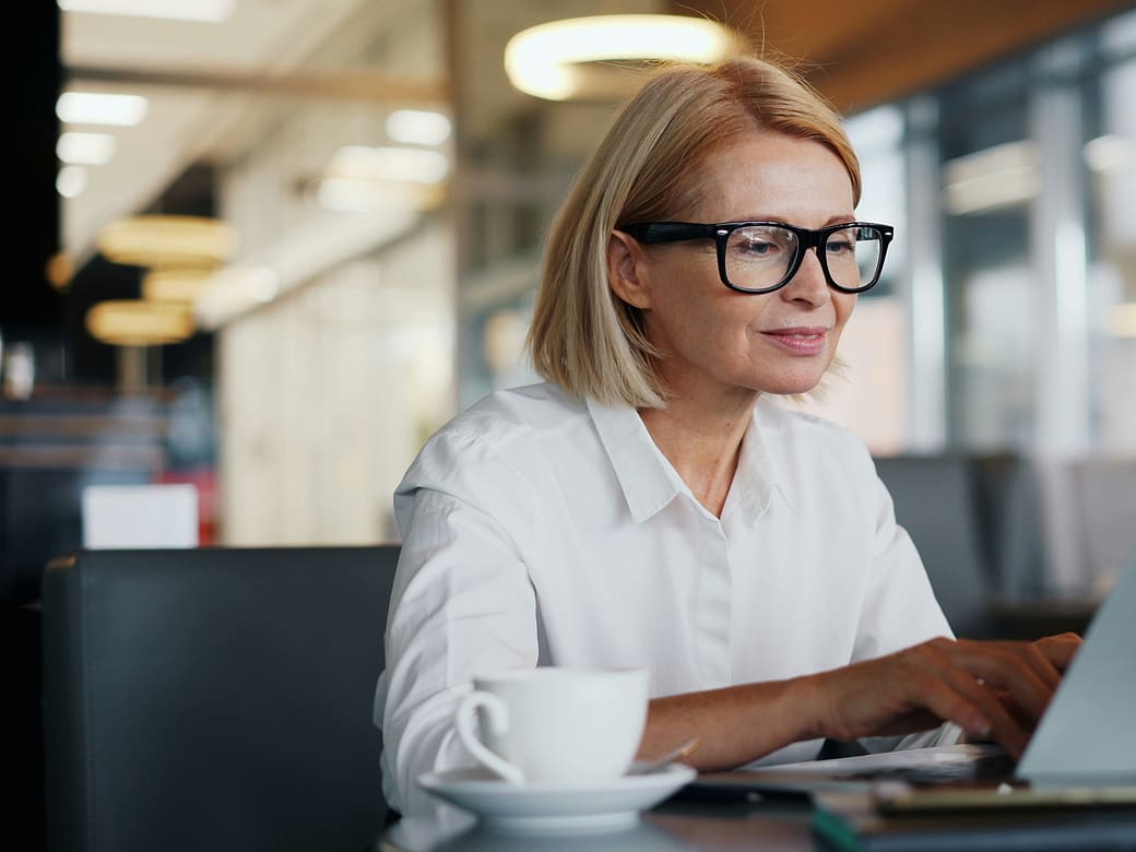 A professional completing an online assessment on her laptop