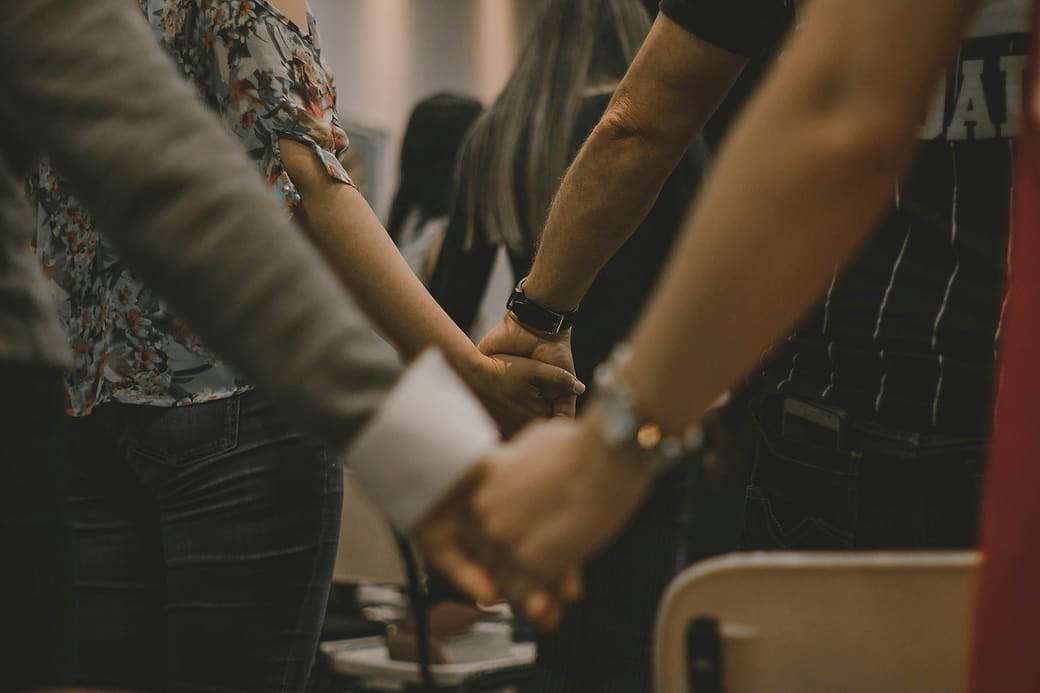 People holding hands in a circle